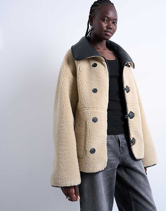 https://images.asos-media.com/products/topshop-shearling-oversized-reversible-coat-with-button-loop-in-black-and-cream/208044418-1-blackcream?$n_750w$&wid=750&fit=constrain