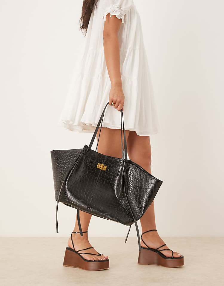 https://images.asos-media.com/products/gina-tricot-faux-leather-medium-tote-bag-with-strap-and-clutch-detail-in-black-croc/208423991-1-black?$n_750w$&wid=750&fit=constrain