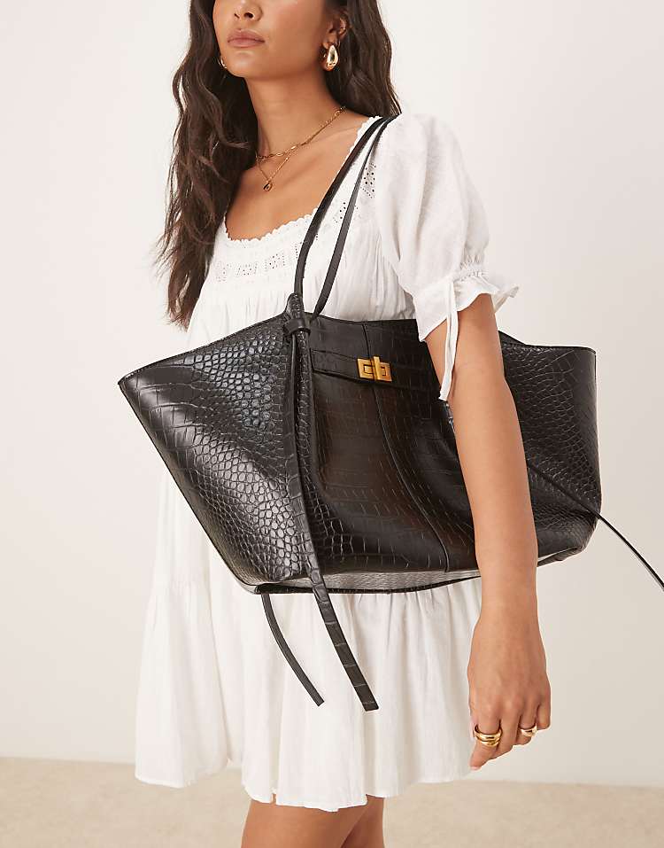 https://images.asos-media.com/products/gina-tricot-faux-leather-medium-tote-bag-with-strap-and-clutch-detail-in-black-croc/208423991-2?$n_750w$&wid=750&fit=constrain