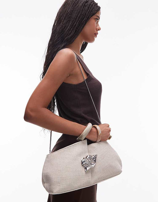 https://images.asos-media.com/products/other-stories-canvas-clutch-with-silver-brooch-leaf-and-removeable-silver-strap-in-dark-beige/208719638-1-darkbeige?$n_750w$&wid=750&fit=constrain