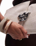 https://images.asos-media.com/products/other-stories-canvas-clutch-with-silver-brooch-leaf-and-removeable-silver-strap-in-dark-beige/208719638-3?$n_750w$&wid=750&fit=constrain