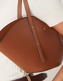 https://images.asos-media.com/products/gina-tricot-faux-leather-small-wide-shopper-bag-in-brown-camel/208784235-3?$n_750w$&wid=750&fit=constrain
