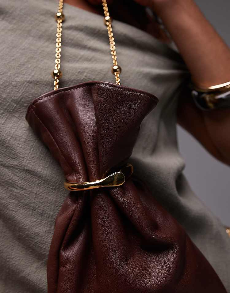 https://images.asos-media.com/products/mango-featuring-kaia-gerber-real-leather-pouch-bag-with-beaded-handle-in-dark-brown/208802033-3?$n_750w$&wid=750&fit=constrain