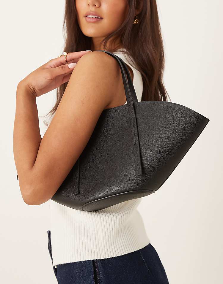 https://images.asos-media.com/products/gina-tricot-faux-leather-small-wide-shopper-bag-in-black/208803818-2?$n_750w$&wid=750&fit=constrain